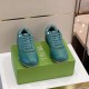 Front view of pair of green Dior B27 trainers sitting on green product box in green and white