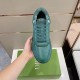 Overhead view of hand holding single green Dior B27 trainer above box in green and white