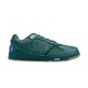 Side profile view of Dior B27 low-top trainer in green leather and canvas on plain white background