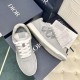 Dior B27 low top grey trainer showing side profile and lace-up details in grey and white