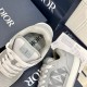 Close-up view of the padded tongue with CD logo on the Dior B27 grey trainer in grey and white
