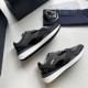 Pair of grey and black Dior B29 low top trainers laid flat