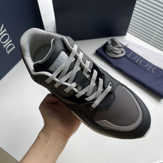 Handheld top view showing Dior CD logo on tongue badge in grey and black