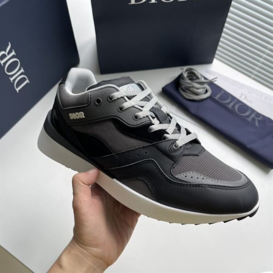 Handheld lateral view of grey and black Dior B29 trainer