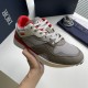 Dior B29 Grey And Red Low Top Trainer Front Angle Dior B29 Grey And Red Low Top Trainer held three-quarter front angle view