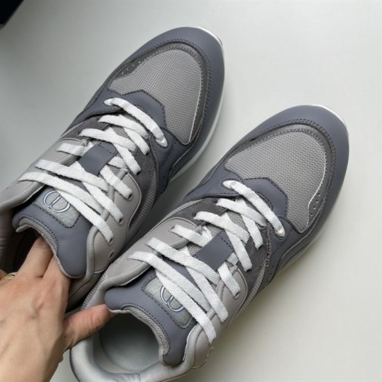 Close-up of the front uppers and white lacing on Dior grey trainers