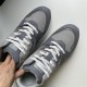 Close-up of the front uppers and white lacing on Dior grey trainers