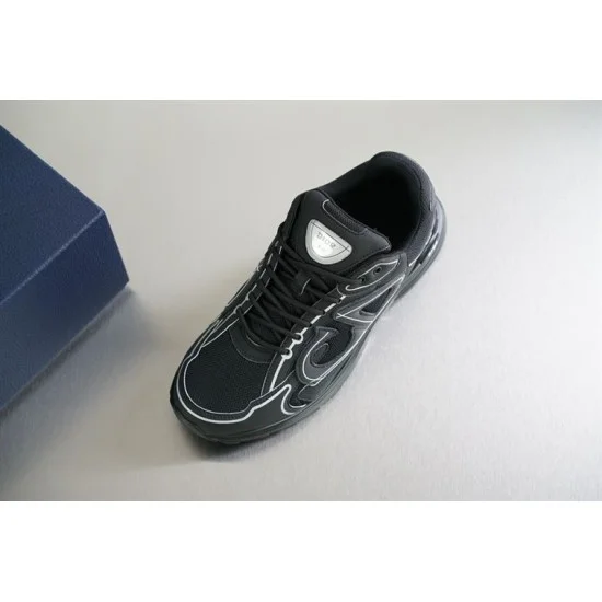 Close-up angled view of Dior B30 black mesh trainer showing tongue badge