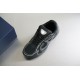 Close-up angled view of Dior B30 black mesh trainer showing tongue badge