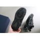 Hand holding the bottom tread pattern of black Dior B30 rubber outsole
