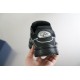 Rear heel view of Dior B30 black trainer held in hand showing CD logo emblem