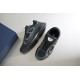 Angled top pair arrangement of Dior B30 black low top trainers