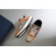 Dior B30 Trainers Pair Angle in beige and orange Angled pair arrangement of Dior B30 trainers showcasing uppers and soles in beige and orange