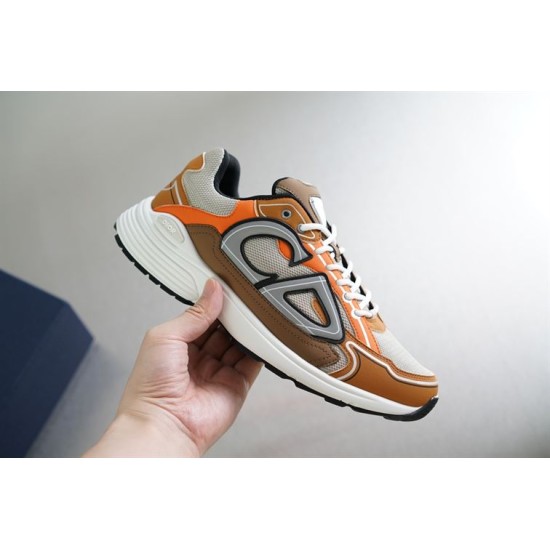 Dior B30 Lateral View in beige and orange Hand holding Dior B30 trainer in beige orange and brown lateral side