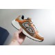 Dior B30 Lateral View in beige and orange Hand holding Dior B30 trainer in beige orange and brown lateral side