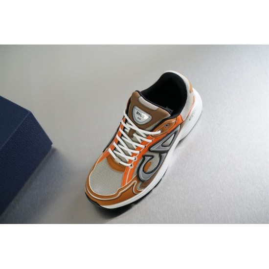 Dior B30 Front View in beige and orange Elevated front view of Dior B30 trainer showing tongue badge and laces in beige and orange