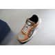 Dior B30 Front View in beige and orange Elevated front view of Dior B30 trainer showing tongue badge and laces in beige and orange