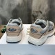 Rear heel view of Dior B30 trainers showing CD logos and light pink accents in grey and pink