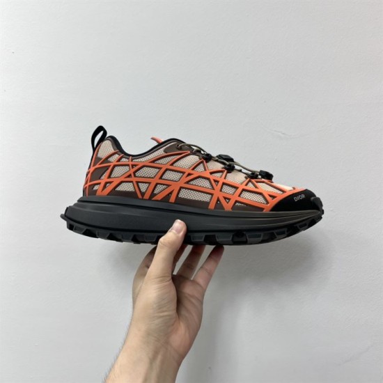Dior B31 Runner Handheld Profile View in beige and orange Hand holding the side profile of a Dior B31 Runner trainer in beige and orange