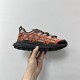 Dior B31 Runner Handheld Profile View in beige and orange Hand holding the side profile of a Dior B31 Runner trainer in beige and orange