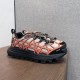 Dior B31 Runner Trainers Angled View in beige and orange Dior B31 Runner trainers in beige and orange shown from an elevated side angle