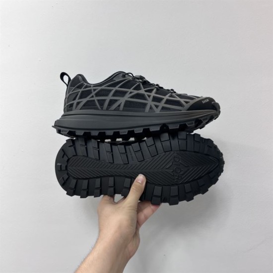 Dior B31 Runner Black Mesh Trainer Outsole Detail Hand holding Dior B31 Runner Black Mesh Trainer showcasing the textured lug outsole.