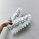 Dior B31 Runner Low Top Trainers In White Grey Held View Hand holding Dior B31 Runner Low Top Trainers in white grey showing lateral mesh and overlay construction