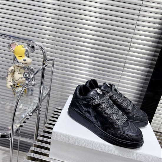 Dior B9S Black Quilted Leather Trainers Perspective View Side and top prospective shot of black Dior B9S quilted low top trainers on white display stand.
