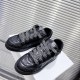 Dior B9S Black Quilted Leather Low Top Trainers Pair View Top angled view of pair of Dior B9S black quilted leather low top trainers on white block.