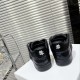 Dior B9S Black Quilted Leather Trainers Heel View Rear view of black Dior B9S trainers highlighting white embroidered flower emblem on heels.