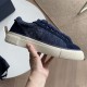 Dior Tears B33 Navy Blue Trainer Medial Side View in navy blue and cream Medial side view of Dior Tears B33 navy blue canvas trainer held in hand in navy blue and cream