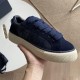 Dior Tears B33 Navy Blue Trainer Handheld Perspective in navy blue and cream Hand holding Dior Tears B33 navy blue trainer displaying cream textured sole and suede details