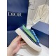 Dior B33 Blue Trainer Handheld Side View Hand holding a Dior B33 blue trainer displaying the thick off-white sole and side texture