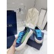 Dior B33 Blue Trainer Handheld Outer Profile Hand holding a Dior B33 blue trainer showing outer side striped panel and chunky laces