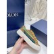 Dior B33 Trainer Sole and Upper Detail in brown and yellow Close-up of the cream outsole and striped side upper on Dior B33 brown suede trainer in brown and yellow