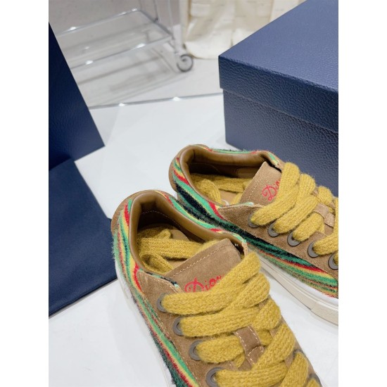 Dior B33 Tongue and Lace Detail in brown and yellow Close-up of the tongue embroidery and thick yellow laces on Dior B33 trainers in brown and yellow