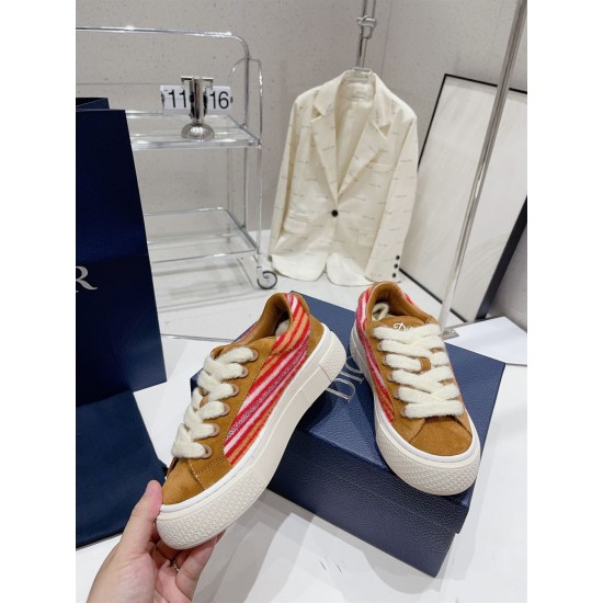 Dior B33 Trainer Lateral View in brown and red Side profile of Dior B33 Striped Canvas And Suede Low Top Trainer held near the box in brown and red
