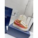 Dior B33 Trainers Pair on Box in brown and red Pair of Dior B33 Striped Canvas And Suede Low Top Trainers resting on a blue shoe box in brown and red