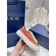 Dior B33 Sole and Profile Detail in brown and red Hand holding a Dior B33 Striped Canvas And Suede Low Top Trainer showing the thick rubber sole in brown and red