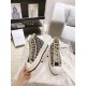 Dior Walk'n'dior High-Top Platform Trainer Held Side View in blue and beige Hand holding a Dior Walk'n'dior High-Top Platform Trainer showing outer side profile in blue and beige