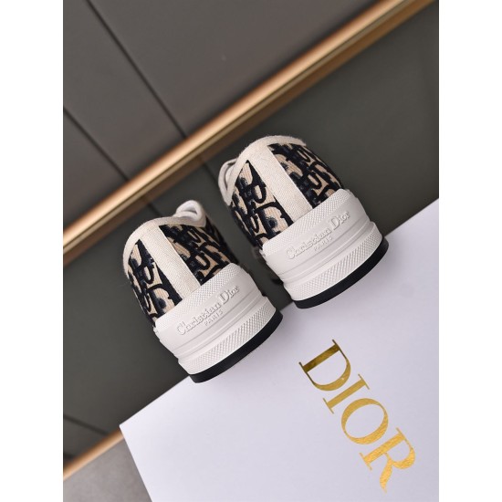 Rear angle of Dior navy blue canvas trainers showcasing embossed heel branding
