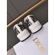 Rear angle of Dior navy blue canvas trainers showcasing embossed heel branding