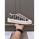 Hand displaying the inner side profile of a Dior navy blue platform canvas trainer
