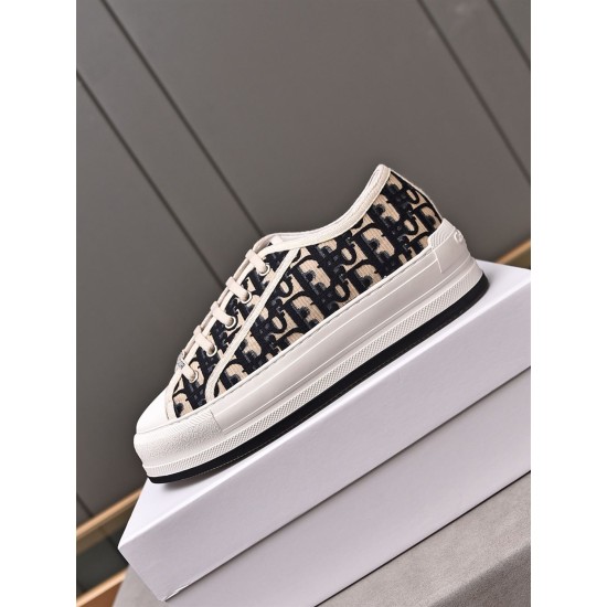 Close-up profile of Dior navy blue canvas platform trainer resting on a white box