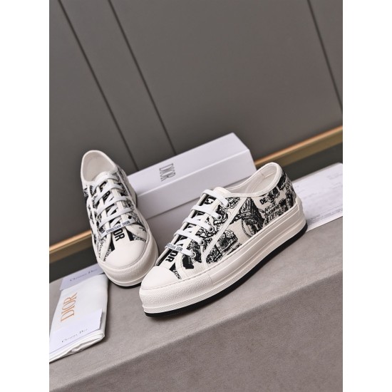 Front oblique view of Dior Walk'n'dior low-top trainers featuring white laces and printed uppers in white and black
