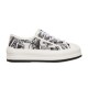 Full side profile of Dior Walk'n'dior platform low-top trainer in white and black print on a plain background