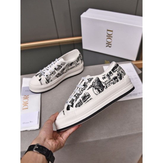 Hand holding a Dior Walk'n'dior platform trainer showing the side profile and printed canvas detail in white and black