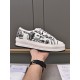 Hand holding the inner profile of a Dior Walk'n'dior printed canvas platform trainer in white and black