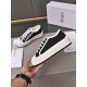 Dior Platform Trainer Handheld Perspective in black Hand holding a Dior black canvas platform low-top trainer