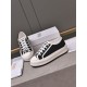 Dior Platform Low-Top Trainers Studio Overview in black Dior Walk'n'dior black low-top trainers placed beside branded box